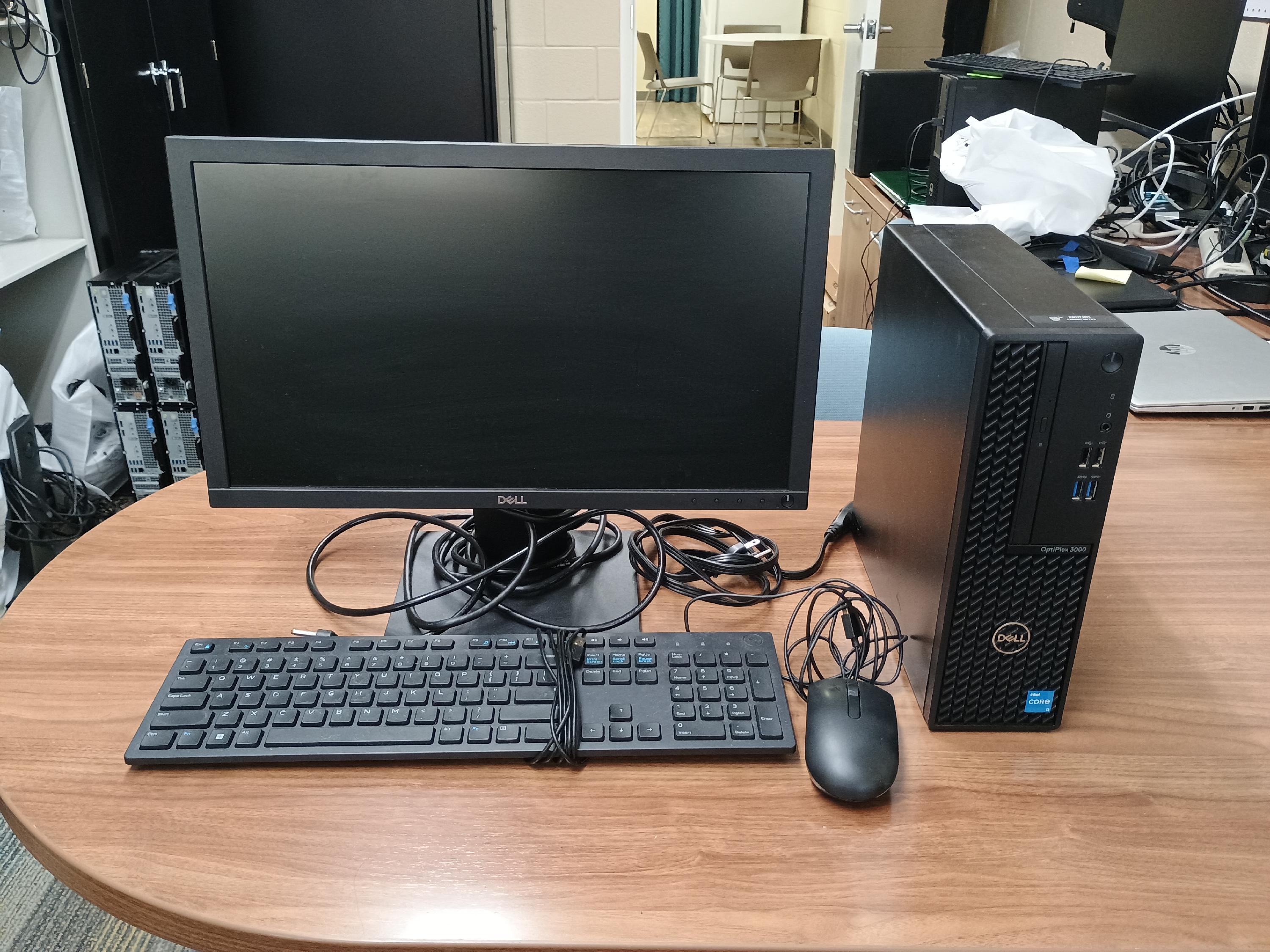 Desktop computer with monitor, keyboard, mouse and cables.